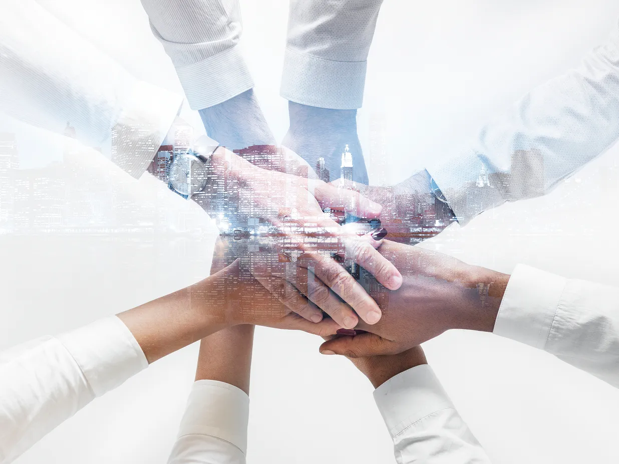 A diverse business team joining hands